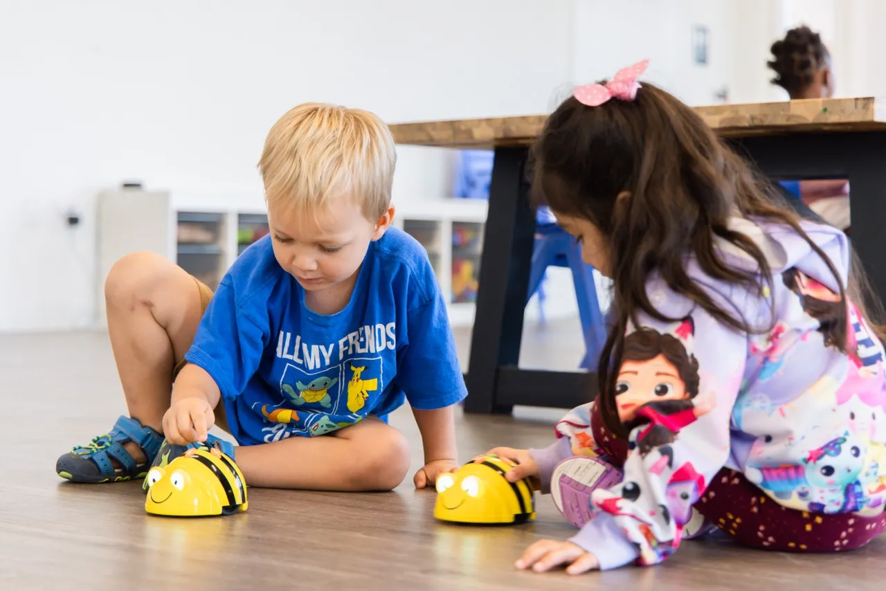 Teacher helping student with STEAM activities